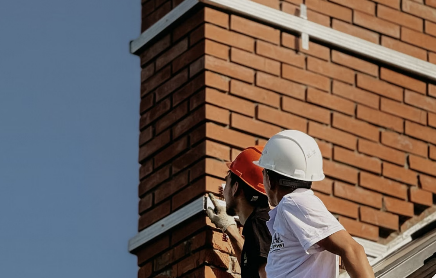 Brick chimney masonry being repaired